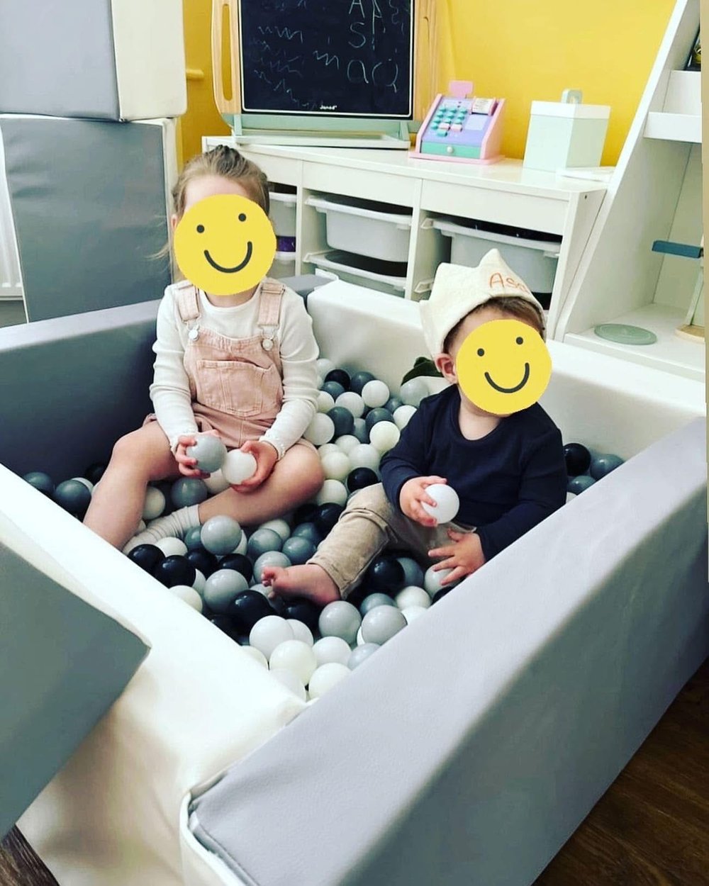 Two little ones enjoying the ball pit